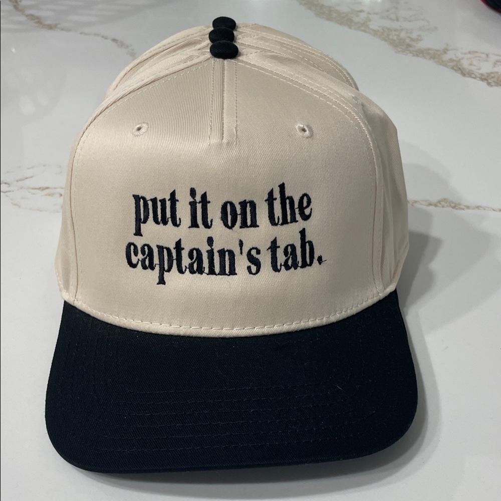 PUT IT ON THE CAPTAIN’S TAB Black and Cream Embroidered Hat